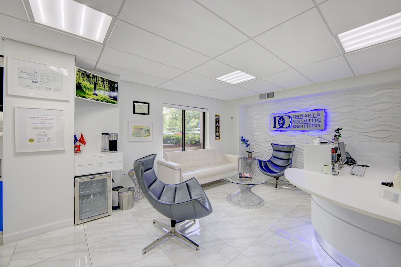 Waiting area with modern seating and the DC Implant & Cosmetic Dentistry sign on the wall